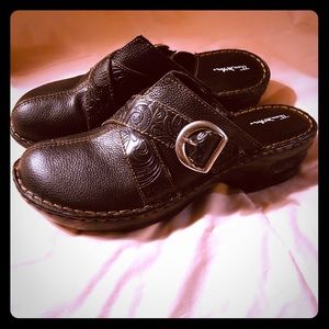 Black mules with silver buckle.